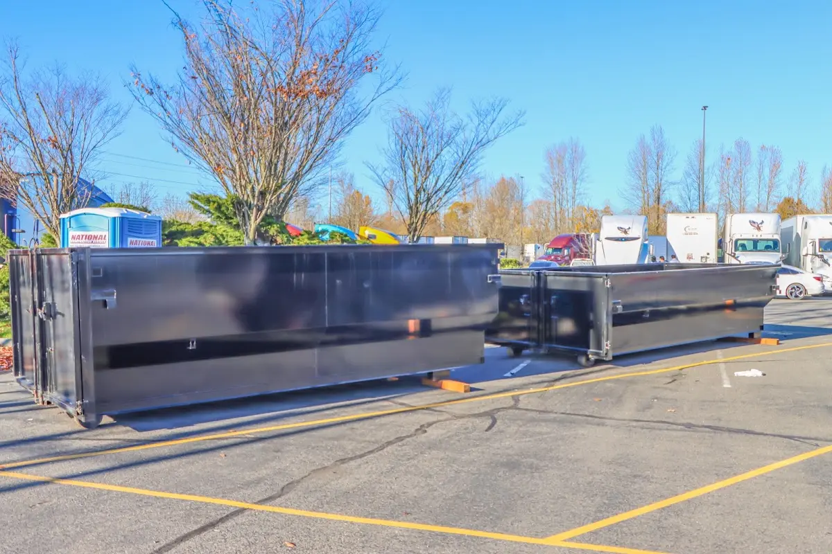 Professional dumpster rental service with roll-off container on residential driveway in Odessa